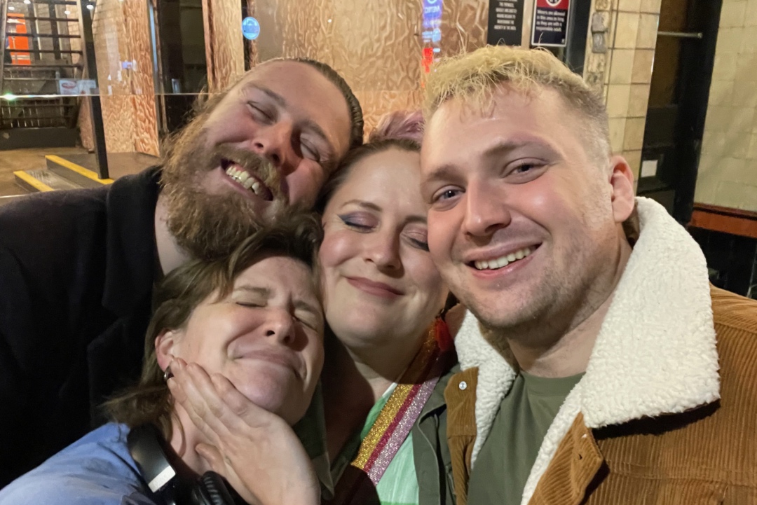 A selfie of Max with three friends, all of whom are grinning ecstatically